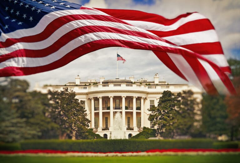 The White House with waving American flag