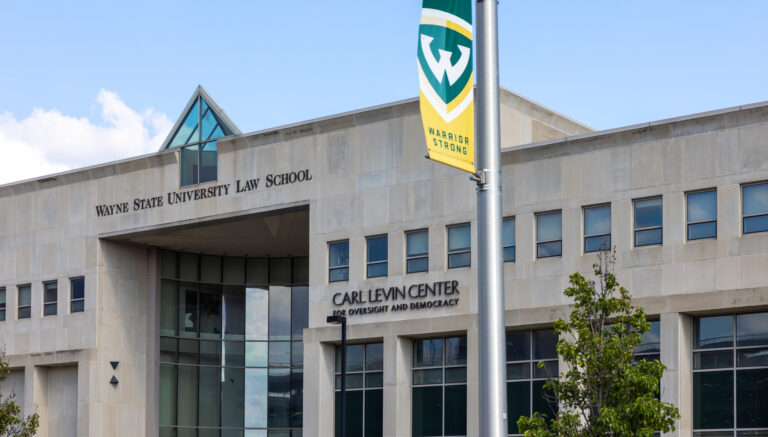 Front Facade picture of the Wayne State Law School Building with flag