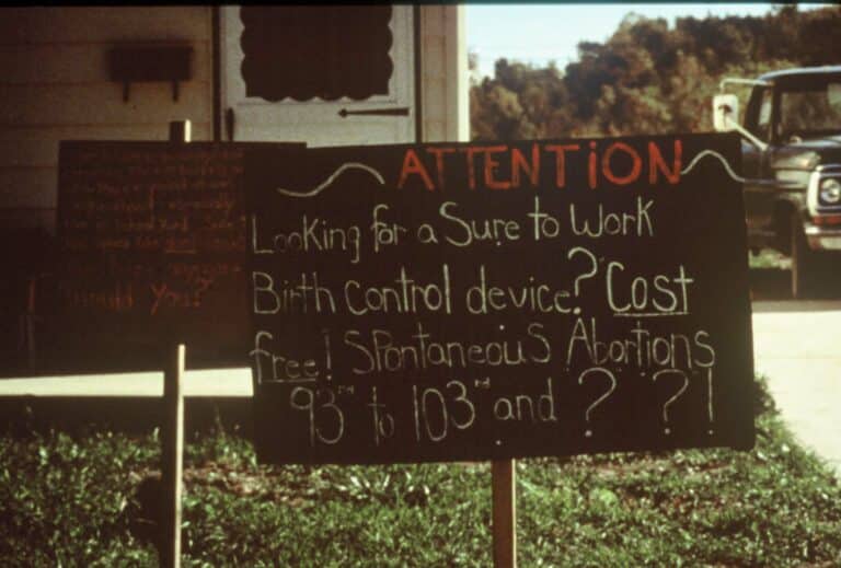 Lawn sign saying "Attention! Looking for a Sure to Work Birth Control device? Cost free! Spontaneous Abortions 93rd to 103rd and ??!"